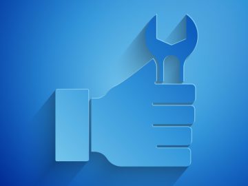 Paper cut Wrench spanner icon isolated on blue background. Paper art style. Vector.